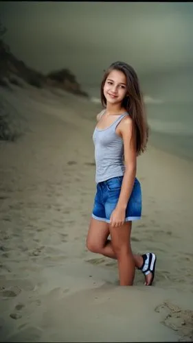 a cute little girl in a gray shirt and denim shorts,beach background,girl on the dune,image editing,walk on the beach,photographic background,blurred background