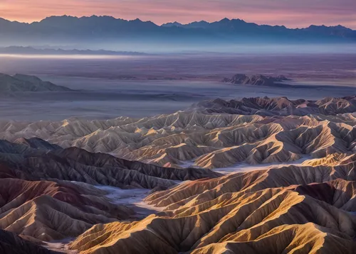 Sun breaks through to highlight the ridges as the fog clears in the badlands of Death Valley National Park.  This image is part...,great dunes national park,death valley,the gobi desert,gobi desert,th