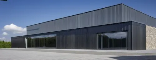 two storeys building with dark grey natural metal cladding in vertical panels 1mt widht, canopy in natrual grey metal sheets and first floor with vertical line textured stone,prefabricated buildings,m