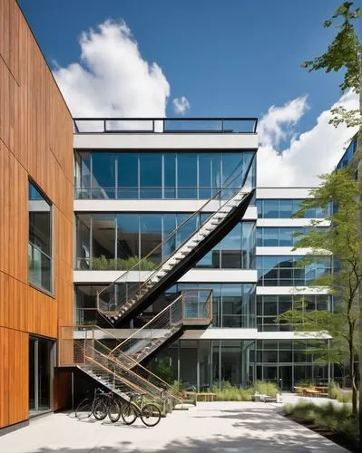 Boston Center for Architecture, modern building, glass facade, steel structure, urban landscape, cityscape, daytime, blue sky, fluffy white clouds, people walking, bicycles parked, outdoor seating are