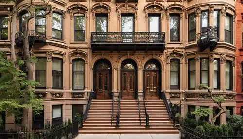 Brownstone Brooklyn residential building, ornate architectural details, intricate stonework, grand entrance, heavy wooden doors, ironwork balconies, decorative railings, large windows, limestone facad