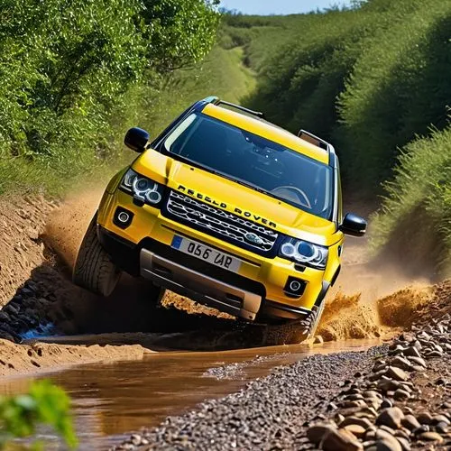 A yellow Land Rover Freelander 3 door 4 wheel car is running on a dirt road. There is a stream blocking the car's running path.,land rover discovery,snatch land rover,land-rover,land rover defender,la