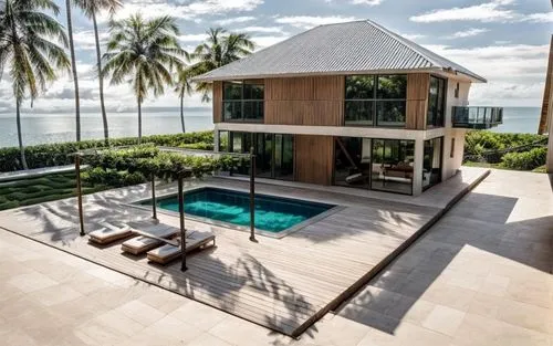 An ultra-luxurious villa with the Maldives shoreline and lush forests in the background.,a view of a villa that is next to the ocean,holiday villa,beach house,beachfront,oceanfront,tropical house,hous