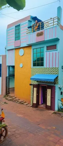 this is an image of a blue building with people on top of it,kovilpatti,nagapattinam,padmanabhapuram,colorful facade,ottapalam,villupuram,anguttara,paravur,puttalam,vilathikulam,papanasam,chengalpattu