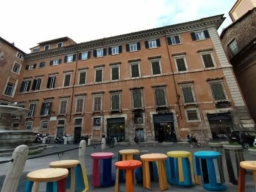 turn the erased  parts to
A table made of colored wood with round colored stools around it,palazzo barberini,trastevere,navona,via della conciliazione,palazzo poli,piazza san marc,piazza di spagna,mod