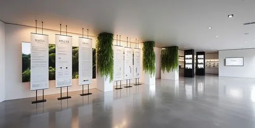 Design a cosmetics pop-up space, exhibition posters are arranged in a row, a monitor is installed on the wall, white is used as the main color, decorated with plants, the floor is polished concrete, s