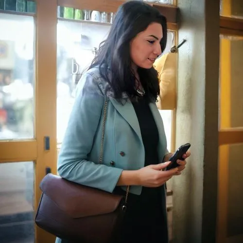 woman holding a smartphone,mobile device,mobile banking,woman at cafe,holding ipad,mobile tablet,businesswoman,leather suitcase,tablets consumer,business woman,woman in menswear,the app on phone,messe