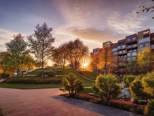 As the afternoon sun begins to set on the horizon on a spring golden light, a vibrant scene unfolds in the sky. In the center of the screen, a cozy residential building.The scene is rendered in high r