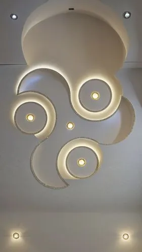 Gypsum decoration in the ceiling of a room with hidden LED lighting the ceiling,a ceiling with a circular lamp and two lights,ceiling light,ceiling lamp,ceiling lighting,ceiling construction,stucco ce