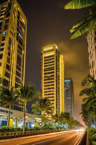 Kochi cityscape, modern architecture, sleek skyscraper, glass façade, steel frame, intricate details, nighttime, city lights, bustling streets, tropical plants, palm trees, warm yellow lighting, 3/4 c