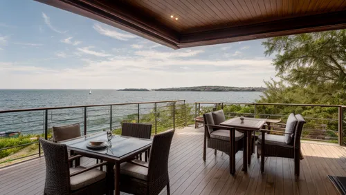 Terrace with lounge table, sea view and mooring with motor boat,landscape design sydney,landscape designers sydney,holiday villa,ocean view,window with sea view,sea view,lake victoria,wooden decking,s