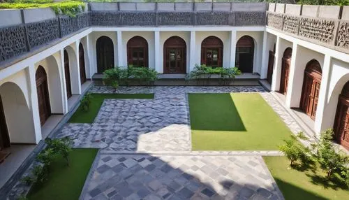 Aayojan School of Architecture and Design, Pune, Maharashtra, Indian architectural style, modern building, white walls, large windows, greenery, courtyard, stone flooring, wooden doors, intricate carv