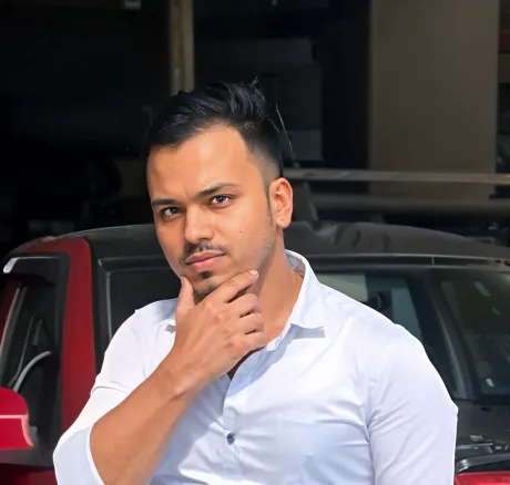 a man wearing a shirt next to a red car,kunchacko,jayasurya,kafeel,sreesanth,kholi,nanjundaswamy