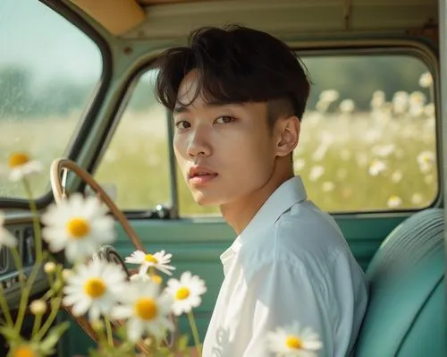 a dreamy masculine average Vietnamese boy sit in a retro car, full of daisies, wearing white shirt, a little heavy-wieghted,a person sitting in a car holding a steering wheel,joon,bobby car,gyu,innisf