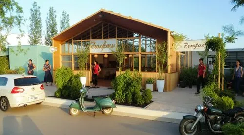 Blue sky 

restaurant

Steel frame construction +  Glass

Colors: Ligth Pink, Light Green, Pine wood.

vertical gardens,people standing outside a el where motorcycles are parked,ecovillages,magdhaba,d