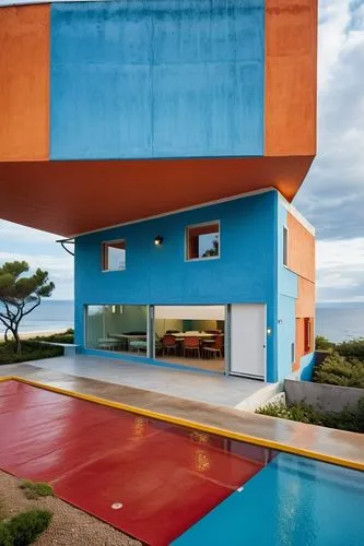 A seaside restaurant, metal sheeting facade, color with white and blue,dunes house,cubic house,cube house,beach house,holiday home,mid century house,mid century modern,house of the sea,corten steel,co