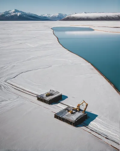 Lithium deposits being harvested from the lake,hydropower plant,salt farming,salt evaporation pond,floating production storage and offloading,salt extraction,sewage treatment plant,mining facility,the