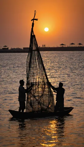 Indian fishermen collect the gargour trap after they repaired them during the sunset of the last day of fishing season at the Jumeirah fishing harbour in Dubai, United Arab Emirates, Friday June 17, 2