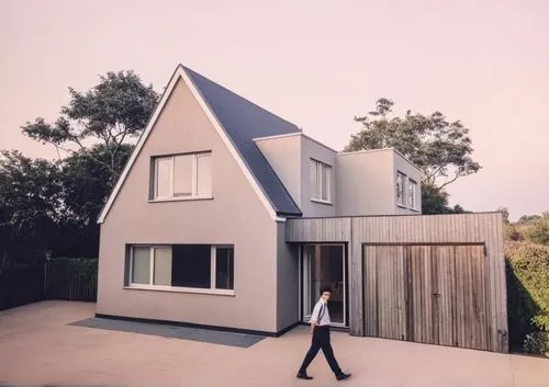 
,the man is walking through the yard in front of a house,cube house,cubic house,frame house,house shape,modern house,timber house,Illustration,Paper based,Paper Based 21