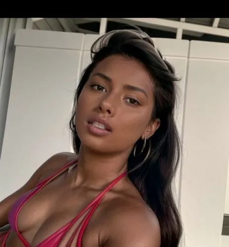 A detailed picture of the whole body.  She doesn't look at the camera.  She is lying on a towel at the beach.  She wears a colorful swimsuit.,taraji,amerie,filipina,filipino,matangi,marshallese,liliya