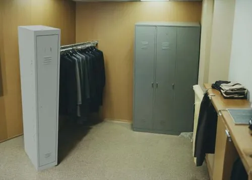 there is a long hallway with a rack of shirts and a locker with a door,wardrobes,walk-in closet,wardrobe,closets,garment racks,changing rooms,cardrooms,garderobe,cloakroom,dressing room,closet,storage