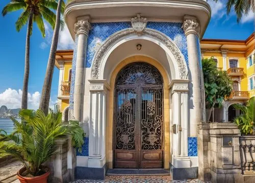 Brazilian colonial-style building, ornate facade, vibrant colorful tiles, curved lines, grand entrance, wooden door, iron gate, palm trees, tropical plants, stone pavement, historic center, Rio de Jan