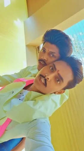 two young men standing next to each other on the side of a wooden floor,baasha,santhanam,sivaji,rajni,chakravarthy,enthiran,murugadoss,balakrishna,balakrishnan,behindwoods,jayaram,subramaniam,chitti,b