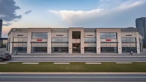 an empty building sitting next to a street,nationalbank,scotiabank,new building,modern building,phototherapeutics,car showroom,company building,equinix,newbuilding,office building,headquarter,multisto