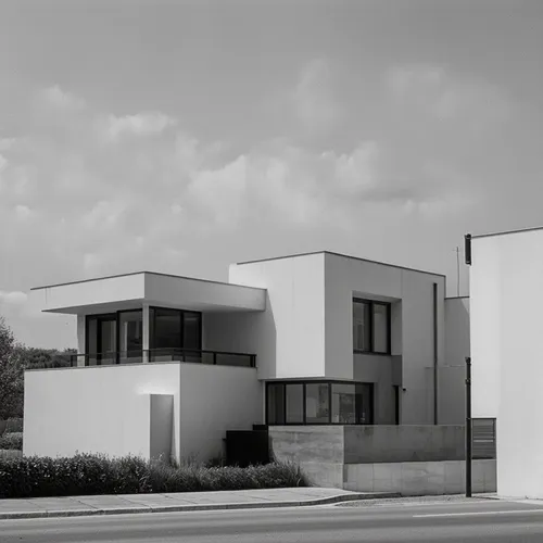 A Bauhaus-style building stands elegantly amidst a minimalist urban landscape, characterized by its pure functionality and geometric precision. The structure boasts clean lines, a monochromatic color 