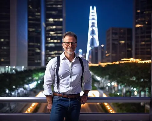 Mid-aged male designer, muscular arms, short brown hair, black-framed glasses, casual smile, white dress shirt, dark blue jeans, brown leather shoes, standing, relaxed pose, in front of a sleek modern