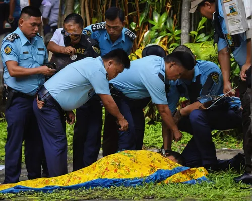 Police investigators hunching over the body of Romeo Torres Fontanilla in Manila, Philippines, on Oct 11, 2016.,navy burial,hay baler aurora,chemical disaster exercise,police crime scene,the protectio