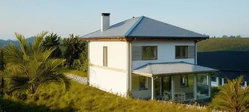 small modern house. The walls are white. Gray roof. There is a forest around the house.,a large white house on a grassy hill,holiday villa,villa,kornhaus,pool house,summer house,house with lake,Photog