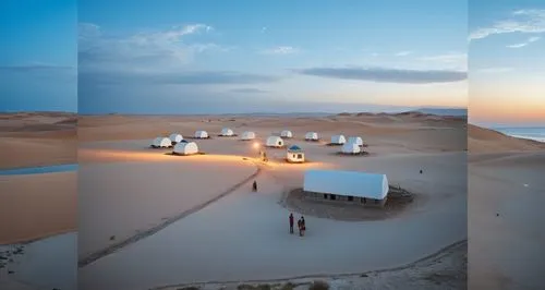 a group of people standing on top of a sandy beach,libyan desert,masdar,aramco,cube stilt houses,mauritanie,liwa,Photography,General,Realistic