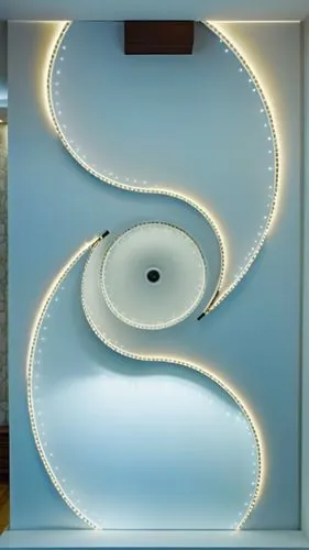 Gypsum decoration in the ceiling of a room with hidden LED lighting,an artful room that has a white and white spiral wall,spiral staircase,circular staircase,spiral stairs,winding staircase,ceiling li