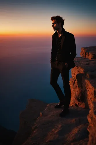 Describe Jon Kortajarena standing on a cliff, overlooking a breathtaking sunset. (Serene),salar de uyuni,above the clouds,cape greco,uyuni,the salar de uyuni,capri,antelope island,santorini,salar uyun