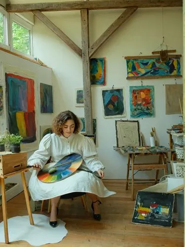 An art professor in her studio.,a woman is sitting in her studio while painting,mousseau,italian painter,giverny,frankenthaler,rohmer,artist portrait,Photography,Documentary Photography,Documentary Ph