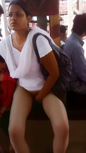 a woman sits on a train while holding a bag,bhabhi,vasanthi,shailaja,pratibha,vibha,suguna