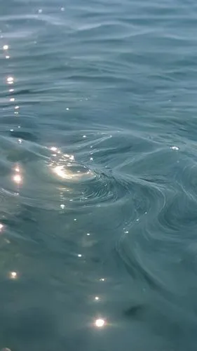 a close up of water with small waves,ripples,water surface,rippling,rippled,water waves,sea water splash