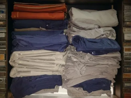 estanteria,a drawer,polo shirts,wardrobe,garment racks,closet,linen,men clothes,walk-in closet,drawer,clothes,khaki pants,drawers,clothing,men's wear,clotheshorse,collection of ties,organized,suit tro