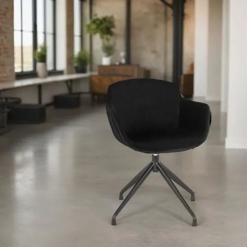 A stylish, modern loft with an industrial aesthetic, featuring a sleek gray velvet chair as the centerpiece. The space is bathed in natural light from large, floor-to-ceiling panoramic windows, offeri