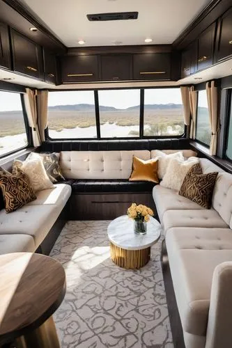 Luxury RV interior, modern minimalist style, creamy white walls, dark wood cabinets, marble countertops, plush beige sofa, patterned velvet throw pillows, golden metal accents, floor-to-ceiling window