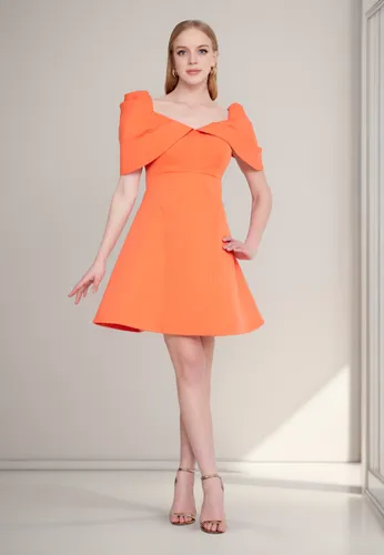 White modern living room with modern sofa behind,orange,plus-size model,bright orange,orange half,orange color,cocktail dress,orange blossom,peach color,tangerine,orange cream,murcott orange,female mo