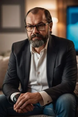 Netflix founder, Lenin-like beard, mature man, 50yo, serious facial expression, black hair, glasses, white shirt, black blazer, jeans, sitting on a couch, watching TV, remote control in hand, backgrou