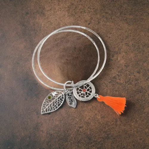 bracelet lies on a white background, top view of the bracelet,necklace with winged heart,orange butterfly,bracelet jewelry,women's accessories,coral charm,feather jewelry,jewelry florets,buddhist pray