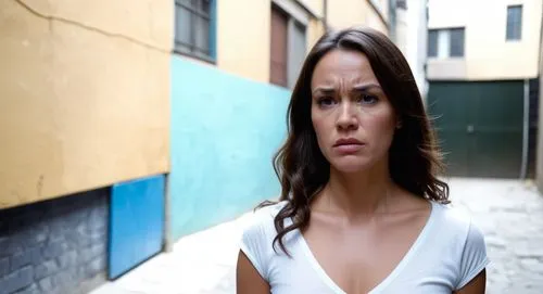 woman frowning and not wearing clothes she is in an alleyway full of criminals,a woman stands in a narrow alleyway with a concerned look,evigan,ivanovic,alsou,abnegation,katniss,aliyeva