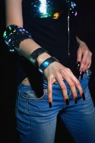 A gloomy, mysterious, slender hand, pale skin, long fingers, black nail polish, silver ring on index finger, worn-out denim cuff, faded black sleeve, dimly lit, dark background, cinematic composition,