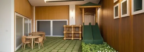 the playground is lit up in a warm light, drenched in a soft, warm light. colourful room with two slide,japanese-style room,greenhut,mudroom,inverted cottage,passivhaus,cubic house,hallway space,rietv