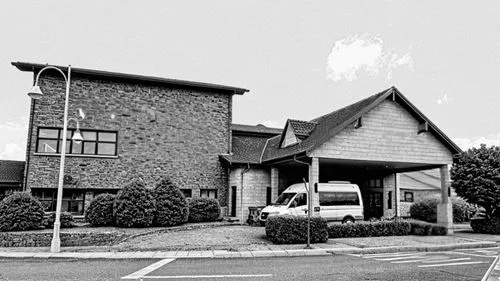 an empty parking lot next to a building with a van in it,midcentury,holy spirit hospital,company headquarters,headquarters,laurelwood,woman church,healthsouth,firehall,clubhouse,company building,count