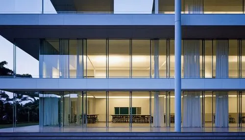 a photograph of a modern school university,  style rem koolhass  floating design, in a coatal part of Vietnam,  shot on a Nikon D700 camera in a very sunset light, in a clear weather day,. The buildin