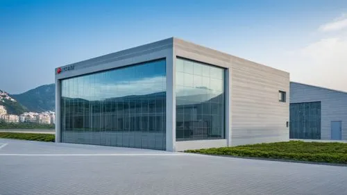 there is a building that has a very big glass window,epfl,hynix,tsmc,equinix,glass facade,unicredit,alinghi,phototherapeutics,sparkasse,modern building,mapfre,nationalbank,new building,metaldyne,merce